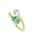A 18k yellow gold you and me design ring featuring a rectangular emerald-cut gemstone and a pear-cut diamond.