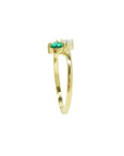 You and Me emerald and diamond ring features a paired pear-cut natural diamond, handcrafted in 18k yellow gold.