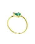 This exquisite You and Me emerald and diamond ring in the classic toi et moi style, handcrafted in 18k yellow gold.