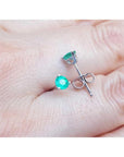 14K white gold martini stud earrings with round and pear-cut green emeralds, push backs.