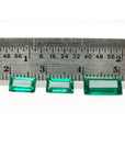 Matched trio set natural loose colombian emeralds 2.78 ct. front side table and crown visible with a ruler sizer