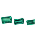 Three emerald-cut natural Colombian emeralds, varying in size, for earrings and pendant.