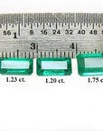 Three emerald-cut natural Colombian emeralds (1.23, 1.20, 1.75 ct) displayed with a ruler.