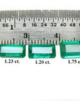 Three emerald-cut natural Colombian emeralds (1.23, 1.20, 1.75 ct) displayed with a ruler.