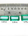 Three emerald-cut natural Colombian emeralds (1.23, 1.20, 1.75 ct) displayed with a ruler.