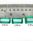 Three emerald-cut natural Colombian emeralds (1.23, 1.20, 1.75 ct) displayed with a ruler.