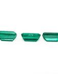Three emerald-cut natural Colombian emeralds, a matched set for earrings and a pendant.