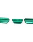 Three emerald-cut natural Colombian emeralds, a matched set for earrings and a pendant.