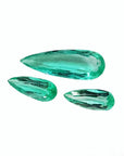 Three loose, pear-shaped Colombian emeralds with sparkling medium light green color.