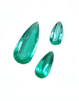 Three pear-shaped, medium light green Colombian emeralds, eye-clean and sparkling.