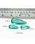 Loose emeralds pear shaped match Set, 4.32 ct. front right side tables and crowns visibles with a ruler sizer and weights labels