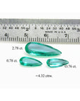 4.32 ct pear-shaped Colombian emeralds in a matching set, shown with a ruler for scale.