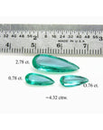 4.32 ct pear-shaped Colombian emeralds in a matching set, shown with a ruler for scale.