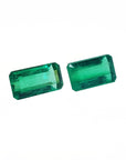 Two emerald matching pair gemstones on a white background