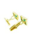 Pair of 14K yellow gold cufflinks with square emerald-set faces and a hinged back.