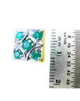 A square design emerald cufflink five stone next to a ruler for scale on a white background.