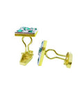 These pair of yellow gold emerald cufflinks are displaying the side profile view.