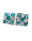 A pair of cufflinks with natural colombian emeralds rund cut displaying the topside view in white gold.