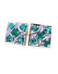 A pair of cufflinks with natural colombian emeralds rund cut displaying the topside view in white gold.