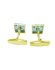Gold cufflinks with colombian emeralds showing the underside profile on a white background