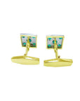 Gold cufflinks with colombian emeralds showing the underside profile on a white background