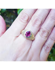 Men's 18K yellow gold ring with a sparkling pinkish-red oval Burma ruby, prong-set.