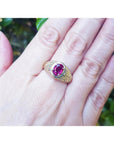 Men's 18K yellow gold ring with a sparkling pinkish-red oval Burma ruby, prong-set.
