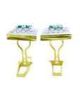 The downside profile view of a pair of yellow gold cufflinks foe men with real emeralds and diamonds/