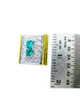 14K yellow gold men's cufflinks with two emeralds surrounded by diamonds, next to a ruler.