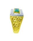 Men's 14K yellow gold ring with a bezel-set emerald and white gold top with floral engravings.