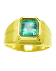 A men’s natural Colombian emerald pinky ring, crafted in 18k yellow gold with a bezel setting.