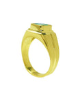A men's emerald pinky ring in yellow gold displaying the top bezel setting and partial sides profile.