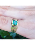 Men's 18K yellow gold pinky ring with a bezel-set, square-cut emerald.