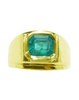 A Men's colombian emerald solitaire ring bezel set crafted in 14k yellow gold.
