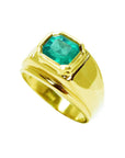 This men's emerald solitaire gold ring with a bezel set displays its top and side profile view.