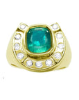 A 14k gold ring for men horseshoe design with a natural colombian emerald and accent diamonds.