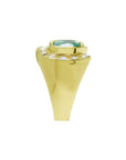 Men's 14K yellow gold horseshoe ring with cushion cut emerald and burnish set diamonds.