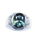 Men's 14K white gold ring with a large oval-cut greenish-blue sapphire and diamond accents.