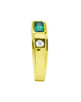 Men's 14K yellow gold ring with a deep green emerald cut Colombian emerald and a side diamond.