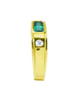 Men's 14K yellow gold ring with a deep green emerald cut Colombian emerald and a side diamond.