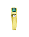 Men's 14K yellow gold ring with a deep green emerald cut Colombian emerald and a side diamond.