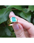 Men's 14K yellow gold solitaire ring with a square emerald-cut, medium green Colombian emerald.
