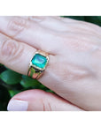 Men's 14K yellow gold solitaire ring with a square emerald-cut, medium green Colombian emerald.