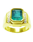 Men's 18K yellow gold ring with a rectangular 2.90 ct Colombian emerald and side diamonds.