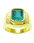 Men's 18K yellow gold ring with a rectangular 2.90 ct Colombian emerald and side diamonds.