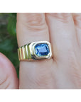 A 18k gold ring with a blue natural blue sapphire gemstone GIA certified bezel set in an east-west orientation.