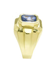 Men's 18K yellow gold ring with a bezel-set, octagonal vivid blue sapphire.