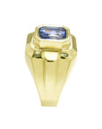 Men's 18K yellow gold ring with a bezel-set, octagonal vivid blue sapphire.