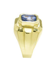 Men's 18K yellow gold ring with a bezel-set, octagonal vivid blue sapphire.