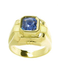 Men's 18K yellow gold solitaire ring with a vivid blue octagonal sapphire.